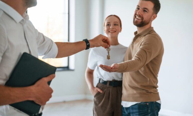 Letting agent handing property keys to tenants, representing professional property management and successful tenancies in Bounds Green.