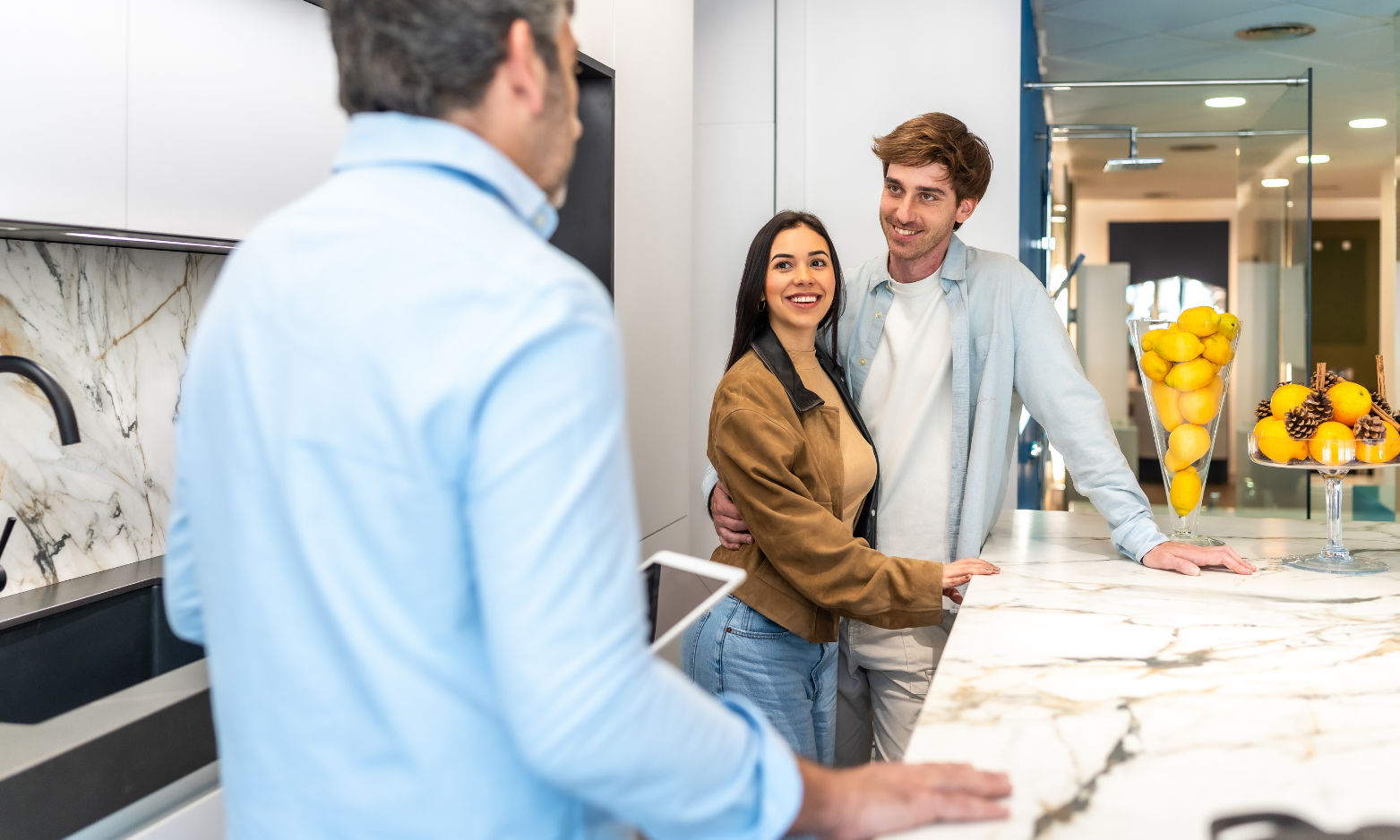 Couple speaking with an estate agent while viewing a modern home in preparation for a property move.