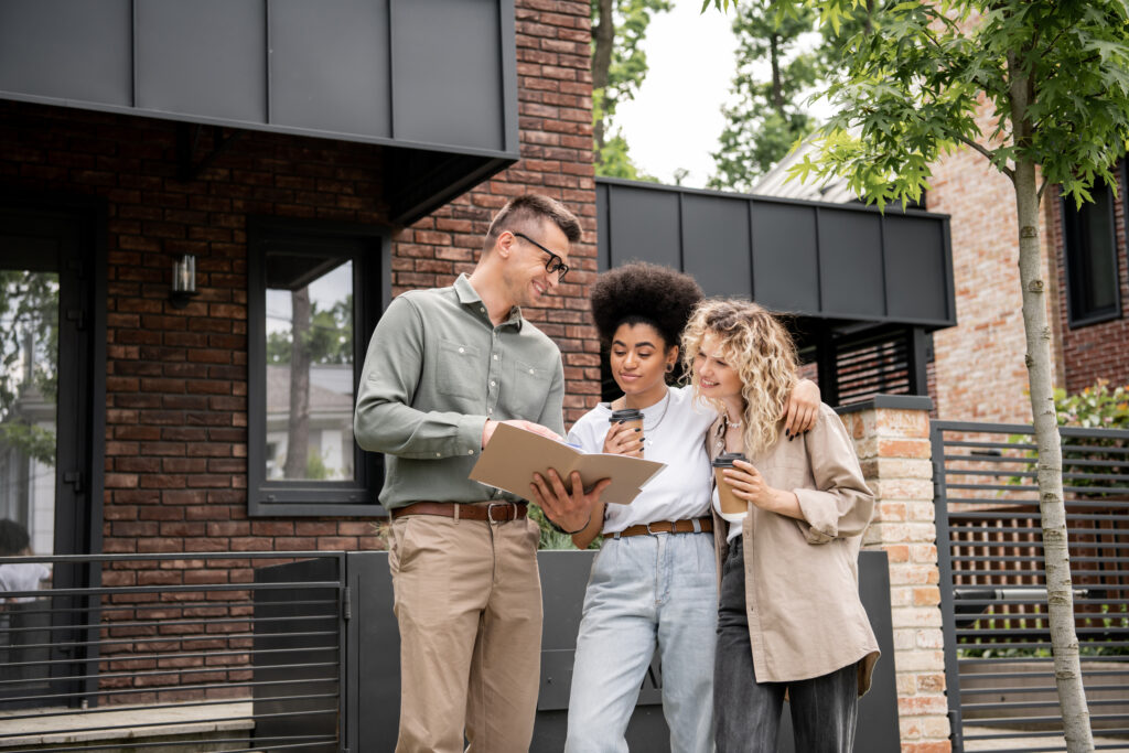 Letting agent discussing property management with landlords outside a residential property in Bounds Green