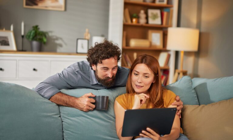 Couple reviewing property information on a tablet at home